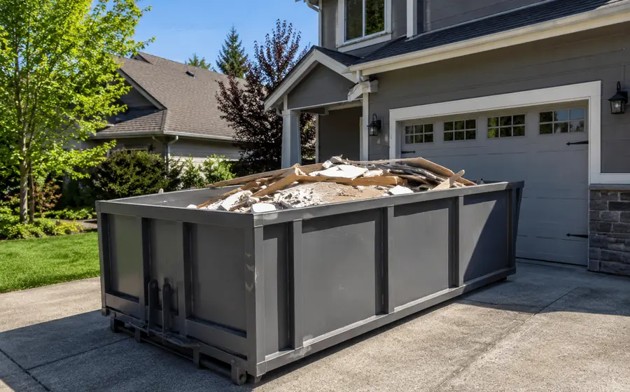Roll-off dumpster in front of a suburban home during a renovation